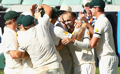 Nathan Lyon of Australia celebrates with his teammates after taking the wicket of Virat Kohli of India during day five of the First Test match between Australia and India at Adelaide Oval on December 13, 2014 in Adelaide, Australia. (Getty)