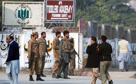 Pakistani security forces takes up a positions on a road leading to the Army Public School that is under attack by Taliban gunmen in Peshawar, December 16, 2014. Taliban gunmen in Pakistan took hundreds of students and teachers hostage on Tuesday in a school in the northwestern city of Peshawar, military officials said.  (REUTERS)