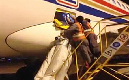 Airport staff manage to deflate the slide, but their rescue work meant a two-hour delay to the flight. (YouTube)