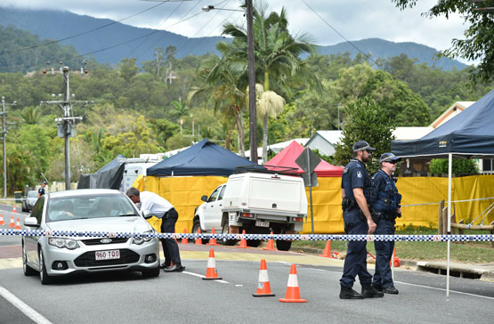 Police corden off the scene on December 20, 2014 where eight children ranging from babies to teenagers were found dead in a house (R) in the northern Australian city of Cairns. The mother of most of the eight children - reportedly found stabbed to death in the house - has been arrested for murder, police said on December 20. (AFP)