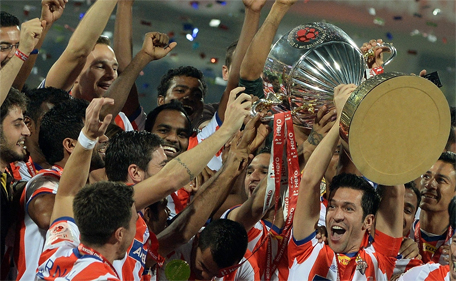 Atletico de Kolkata player Luis Garcia lifts the trophy as he celebrates with teammates after winning the Indian Super League (ISL) final against Kerala Blasters at The D.Y. Patil stadium in Navi Mumbai on December 20, 2014. (AFP)