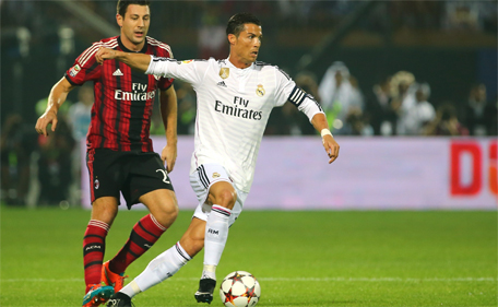 Real Madrid's forward Cristiano Ronaldo (right) vies for the ball against AC Milan's defender Daniele Bonera during their friendly football match on December 30, 2014 at the Sevens Stadium in Dubai. (AFP)