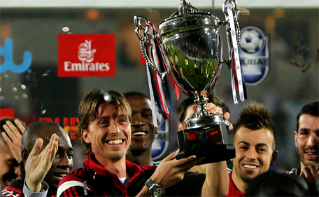 AC Milan's captain Riccardo Montolivo raises a trophy after beating Real Madrid in their friendly football match on December 30, 2014 at the Sevens Stadium in Dubai. (AFP)