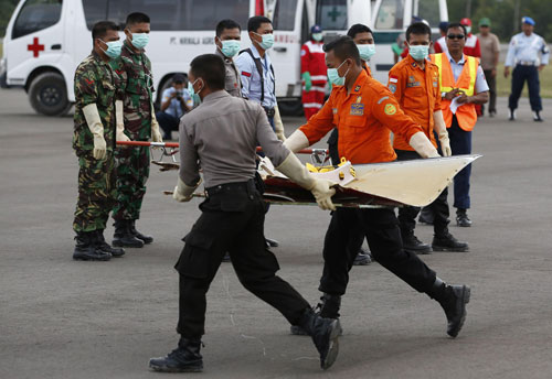 Debris from AirAsia QZ8501, recovered from the Java Sea, is carried from an Indonesian Search and Rescue (BASARNAS) helicopter in Pangkalan Bun, Central Kalimantan January 9, 2015. Indonesia search and rescue teams hunting for the wreck of an AirAsia passenger jet detected pings in their efforts to find the black box recorders on Friday, 12 days after the plane went missing with 162 people on board, an official said. (REUTERS)