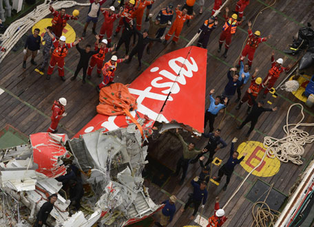 The tail of the Air Asia QZ8501 passenger plane is seen on the deck of the Indonesian Search and Rescue (BASARNAS) ship Crest Onyx after it was recovered at sea on January 10, 2015. (AFP)