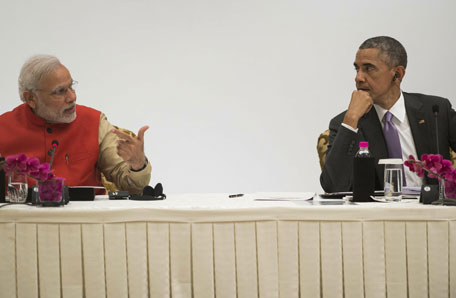 Indian Prime Minister Narendra Modi (L) and US President Barack Obama talk during the India-US Business Summit in New Delhi on January 26, 2015. Rain failed to dampen spirits at India's Republic Day parade January 26 as Barack Obama became the first US president to attend the spectacular military and cultural display in a sign of the nations' growing closeness. (AFP)