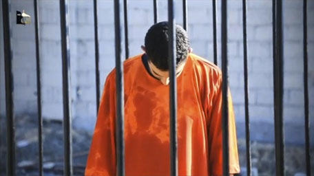 A man purported to be Daesh captive Jordanian pilot Muath Al Kasaesbeh is seen standing in a cage in this still image from an undated video filmed from an undisclosed location made available on social media on February 3, 2015. (Reuters)