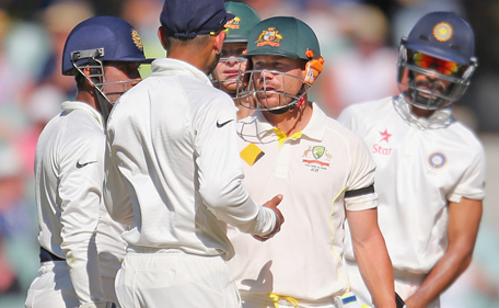 David Warner of Australia and Virat Kohli of India exchange words as Wriddhiman Saha and Shikhar Dhawan of India and Steven Smith of Australia look on during day four of the First Test match between Australia and India at the Adelaide Oval on December 12, 2014 in Adelaide, Australia. (Getty)