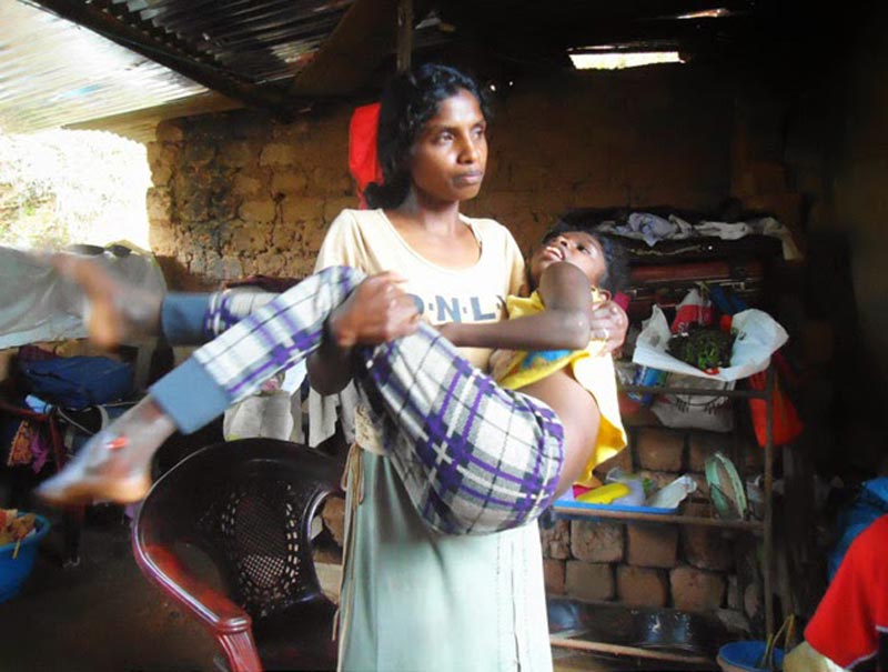 Dilani carried by her mother when she was bed-ridden. (Courtesy: Gossip Lanka)