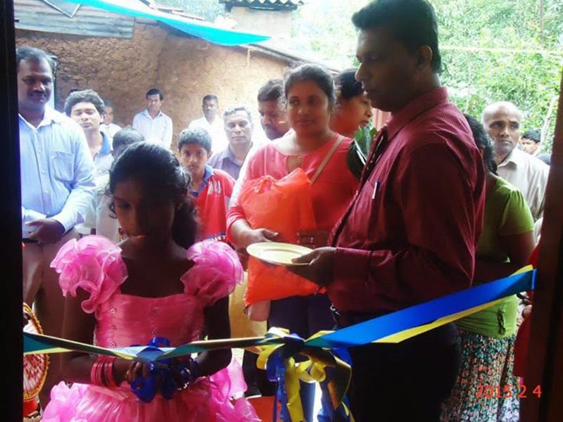 Dilani cutting a ribbon to open her new house built with public donations. (Picture courtesy Gossip Lanka)