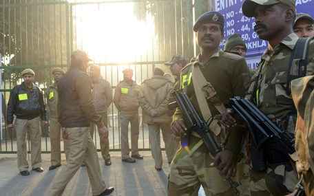 Indian security personnel stand guard at a vote counting centre in New Delhi on February 10, 2015. Counting of votes started for Delhi state elections with exit polls indicating former chief minister Arvind Kejriwal's anti-corruption party has comfortably beaten Prime Minister Narendra Modi's Hindu nationalists. (AFP)