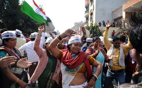 Indian Aam Aadmi Party (AAP) supporters celebrate the AAP's victory in the state assembly elections outside the party's headquarters in New Delhi on February 10, 2015. Indian Prime Minister Narendra Modi conceded defeat on February 10 in the Delhi state elections as early results showed anti-corruption campaigner Arvind Kejriwal's party set for a landslide victory. (AFP)