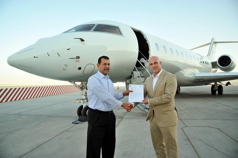 Holger Ostheimer, General Manager at DC Aviation Al-Futtaim (right) receiving the AOC from Capt. Anaziaz Zikir, Senior Inspector – Private and Special Operations, UAE General Civil Aviation Authority. (Supplied)
