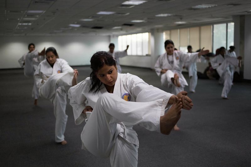 Policewomen practice kicks during a self-defence class in New Delhi. (AFP)