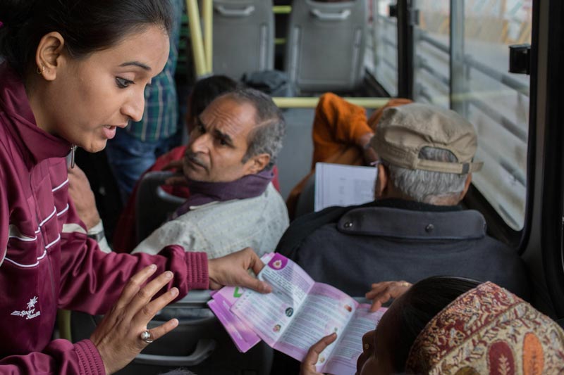 A policewoman (left) speaks to passengers as she and a group of others patrol public buses, hand out safety leaflets and talk to passengers about their safety fears in New Delhi. (AFP)