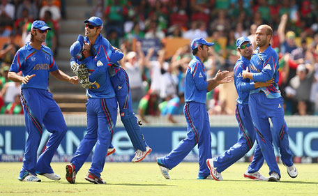 Merwais Ashraf (right) of Afghanistan celebrates with team mates after taking the wicket of Tamim Iqbal of Bangladesh during the 2015 ICC Cricket World Cup match between Bangladesh and Afghanistan at Manuka Oval on February 18, 2015 in Canberra, Australia. (Getty Images)
