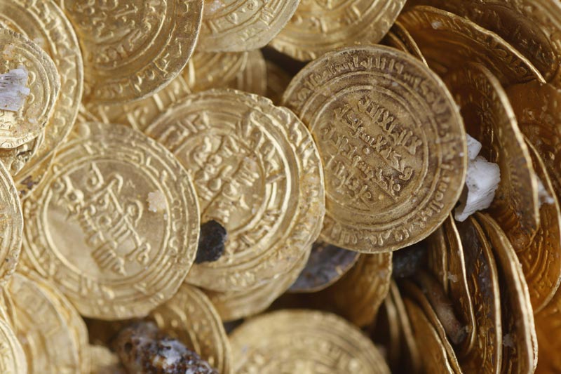 Ancient gold coins are displayed in Caesarea, north of Tel Aviv along the Mediterranean coast February 18, 2015. Almost 2,000 gold coins, believed to be from the 11th century, were found in recent weeks on the seabed by amateur divers. (Reuters)
