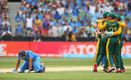 Rohit Sharma (left) of India looks dejected after being run out as South Africa celebrate during the 2015 ICC Cricket World Cup match between South Africa and India at Melbourne Cricket Ground on February 22, 2015 in Melbourne, Australia. (Getty)