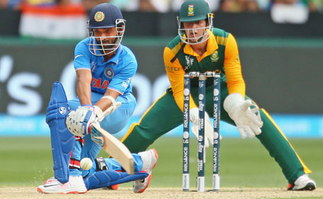 Ajinkya Rahane of India plays a reverse sweep as wicketkeeper Quinton de Kock of South Africa looks on during the 2015 ICC Cricket World Cup match between South Africa and India at Melbourne Cricket Ground on February 22, 2015 in Melbourne, Australia. (Getty Images)