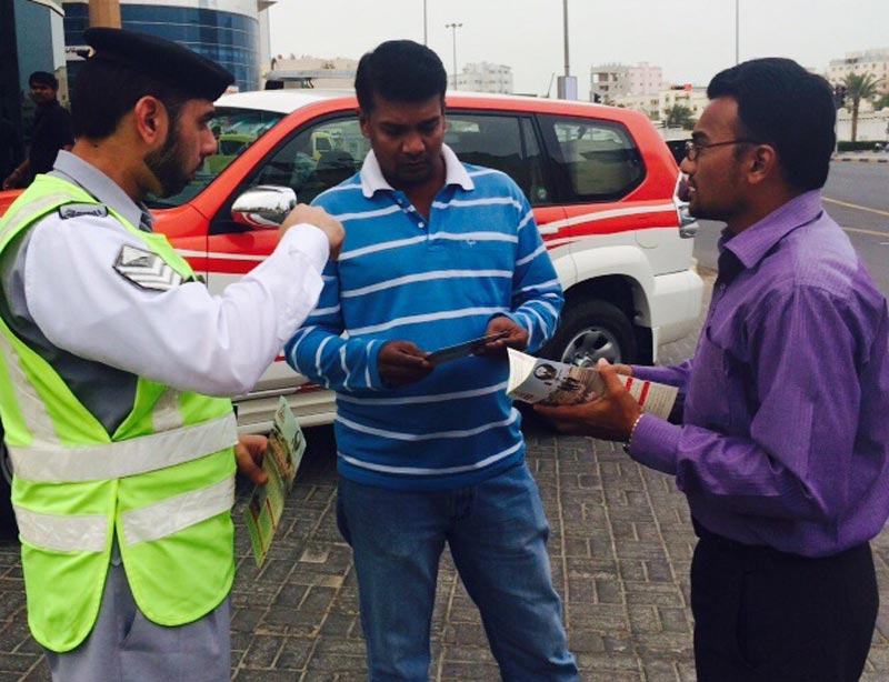 Traffic police distributing leaflets on road safety to pedestrians in Ajman. (Supplied)