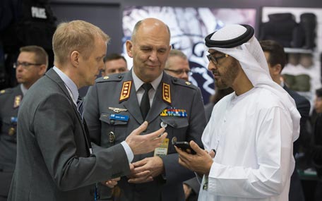 Gen. Sheikh Mohamed bin Zayed speaks with Lt General Arto Raty Deputy Prime Minister of Finland (centre) and a member of the Finnish delegation during a tour of the 2015 International Defence Exhibition and Conference (Idex) at Abu Dhabi National Exhibition Centre (Adnec) on Monday. (Wam)