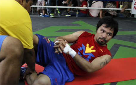Philippine boxing icon Manny Pacquaio stretches prior to a training session at a gym in General Santos City in southern island of Mindanao on February 23, 2015. (AFP)