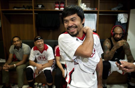 Philippine boxing hero Manny Pacquiao laughs before a basketball game between Kia and Talk and Text in Manila on February 25, 2015. Pacquiao declared himself an enemy of doping on February 25, ahead of a megabucks bout with unbeaten Floyd Mayweather, his longtime rival as the planet's best "pound-for-pound" fighter.   AFP