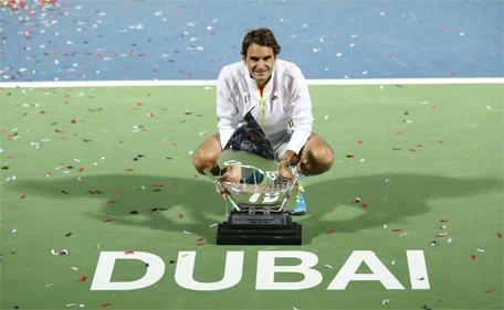 Roger Federer of Switzerland poses with his trophy after winning his final match against Novak Djokovic of Serbia at the ATP Championships tennis tournament in Dubai, February 28, 2015. (Reuters)