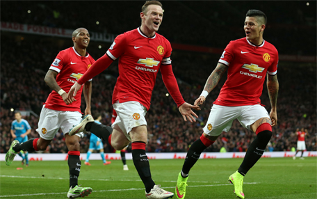 Wayne Rooney celebrates with team mates after scoring the first goal for Manchester United from the penalty spot. (Action Images via Reuters)