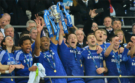 Chelsea's Ivorian striker Didier Drogba (3rd left) and Chelsea's English defender John Terry lift the trophy during the presentation after Chelsea won the League Cup final football match against Tottenham Hotspur at Wembley Stadium in London on March 1, 2015. (AFP)