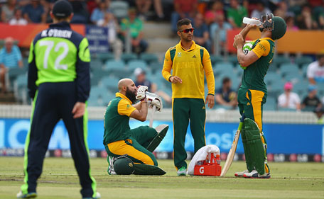 Hashim Amla and Faf du Plessis of South Africa take a drink brink during the 2015 ICC Cricket World Cup match between South Africa and Ireland at Manuka Oval on March 3, 2015 in Canberra, Australia. (Getty Images)