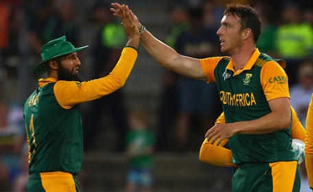 Hashim Amla and Kyle Abbott of South Africa celebrate combining to take the wicket of Niall O'Brien of Ireland during the 2015 ICC Cricket World Cup match between South Africa and Ireland at Manuka Oval on March 3, 2015 in Canberra, Australia. (Getty)