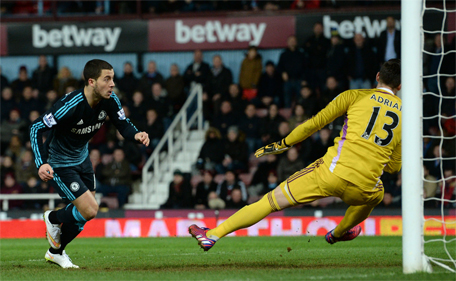 Chelsea's midfielder Eden Hazard (left) scores the opening goal past West Ham United's Spanish goalkeeper Adrian during the English Premier League football match between West Ham United and Chelsea at the Boleyn Ground in Upton Park, East London on March 4, 2015. (AFP)