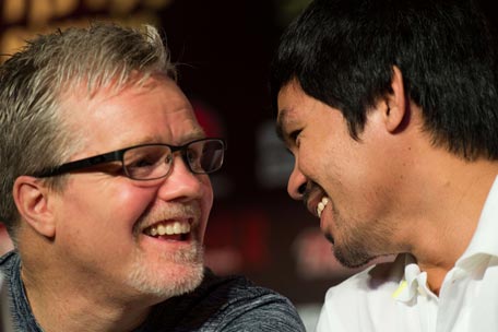 (FILES) Philippine boxing icon Manny Pacquiao (R) and his coach Freddie Roach talk during a pre-fight press conference in Shanghai on August 26, 2014.  Hall of Fame trainer Freddie Roach, who turned 55 on March 5, 2015, has seen it all during a legendary career. But he tells AFP that training Manny Pacquiao to take on Floyd Mayweather on May 2 in boxing's most lucrative fight ever will be "the biggest challenge of my life".  (AFP )