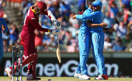 Umesh Yadav and Rohit Sharma of India celebrate the wicket of Denesh Ramdin of the West Indies of the West Indies during the 2015 ICC Cricket World Cup match between India and the West Indies at WACA on March 6, 2015 in Perth, Australia. (Getty)