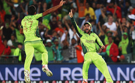 Wahab Riaz of Pakistan celebrates with Ahmad Shahzad of Pakistan after claiming the last wicket of Imran Tahir of South Africa to win the 2015 ICC Cricket World Cup match between South Africa and Pakistan at Eden Park on March 7, 2015 in Auckland, New Zealand. (Getty)