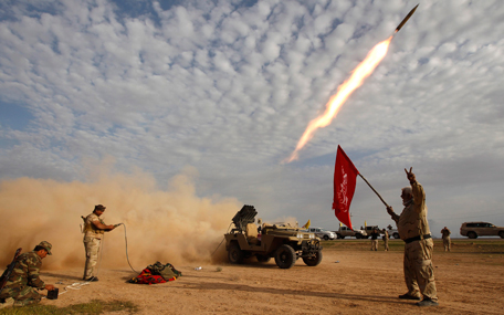 Fighters launch a rocket during clashes with Daesh militants on the outskirts of Al-Alam on March 8, 2015. (Reuters)