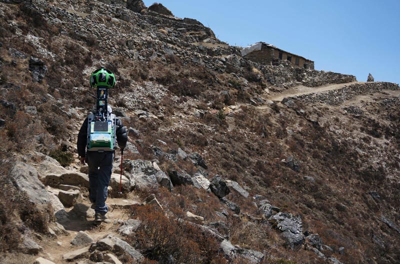In this handout photograph released by Google and taken on April 28, 2014, a memeber of the Google Street View project walks with the camera used to capture project footage through Nepal's Khumbu region. Google has launched a virtual tour of Nepal's rugged Everest region, unveiling a Street View project that follows sky-high trails and suspension bridges for a glimpse of life in the Himalayas. (AFP)