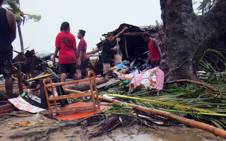 Local residents look through the remains of a small shelter in Port Vila, the capital city of the Pacific island nation of Vanuatu March 14, 2015. Winds of up to 250 kilometers an hour (155 mph) ripped metal roofs off houses and downed trees in Vanuatu on Saturday, as relief agencies braced for a major rescue operation and unconfirmed reports said dozens had already died. Witnesses described sea surges of up to eight meters (yards) and flooding throughout the capital Port Vila after the category 5 cyclone named Pam hit the country late on Friday. (REUTERS)