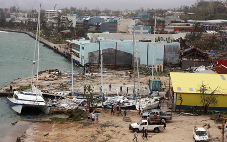 Local residents look at damaged boats washed up into a small inlet in Port Vila, the capital city of the Pacific island nation of Vanuatu March 14, 2015. Winds of up to 250 kilometers an hour (155 mph) ripped metal roofs off houses and downed trees in Vanuatu on Saturday, as relief agencies braced for a major rescue operation and unconfirmed reports said dozens had already died. Witnesses described sea surges of up to eight meters (yards) and flooding throughout the capital Port Vila after the category 5 cyclone named Pam hit the country late on Friday. Picture taken March 14, 2015. (REUTERS)