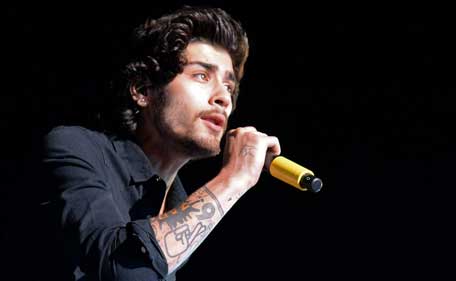 Singer Zayn Malik of One Direction performs onstage during the One Direction 'Where We Are' Tour at Rose Bowl on September 11, 2014 in Pasadena, California. (Getty)