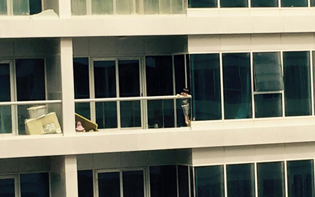 A child, who appears to be not more than five-years-old, is seen throwing a toy over the balcony ledge, before pulling himself up to hang on the edge. [PIX: Jyothi Ferrao on Facebook]