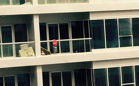 A child, who appears to be not more than five-years-old, is seen throwing a toy over the balcony ledge, before pulling himself up to hang on the edge. [PIX: Jyothi Ferrao on Facebook]
