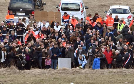 Relatives of the Germanwings Airbus A320 crash victims gather by a stele during a wreath-laying and remembrance ceremony in the small village of Le Vernet on March 26, 2015. A German Airbus A320 of the low-cost carrier Germanwings crashed on March 24, killing all 150 people on board. AFP