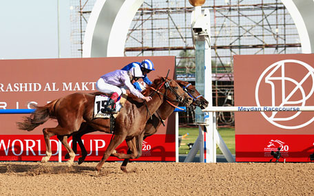 Tamarkuz ridden by Paul Hanagan (blue silks) wins the Godolphin Mile during the Dubai World Cup at the Meydan Racecourse on March 28, 2015 in Dubai, UAE. (Getty Images)