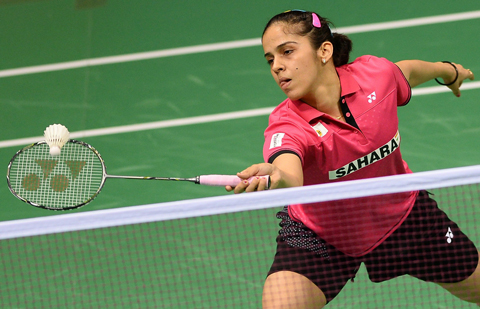 In this photograph taken on March 25, 2015, Saina Nehwal of India plays a shot during her women's badminton singles match against Riay Mukherjee of India at the Yonex-Sunrise India Open 2015 at the Siri Fort Sports Complex in New Delhi. Badminton star Saina Nehwal has shrugged off mounting pressure over whether she will become the first Indian woman ever to clinch the world number one ranking, at the Indian Open in New Delhi. Nehwal, currently number two after reaching the prestigious All-England Championship final this month, is expected to snatch the number one spot if she wins the tournament in front of a home crowd. (AFP)