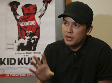In this April 7, 2015 photo, Filipino filmmaker Paul Soriano gestures beside a poster of the movie 'Kid Kulafu', during an interview in suburban Makati, south of Manila, Philippines. (AP)
