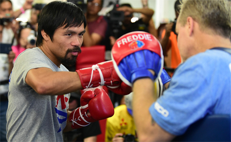 Manny Pacquiao (left) spars with his coach Freddy Roach ahead of his upcoming fight at the Wild Card Boxing Club in Hollywood, California on April 15, 2015. (AFP)