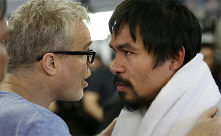 Manny Pacquiao listens to his trainer, Freddie Roach, during a workout Wednesday, April 15, 2015, in Los Angeles. (AP)