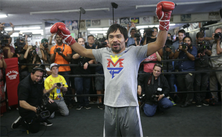 Manny Pacquiao raises his arms after his workout in front of reporters and photographers Wednesday, April 15, 2015, in Los Angeles. (AP)